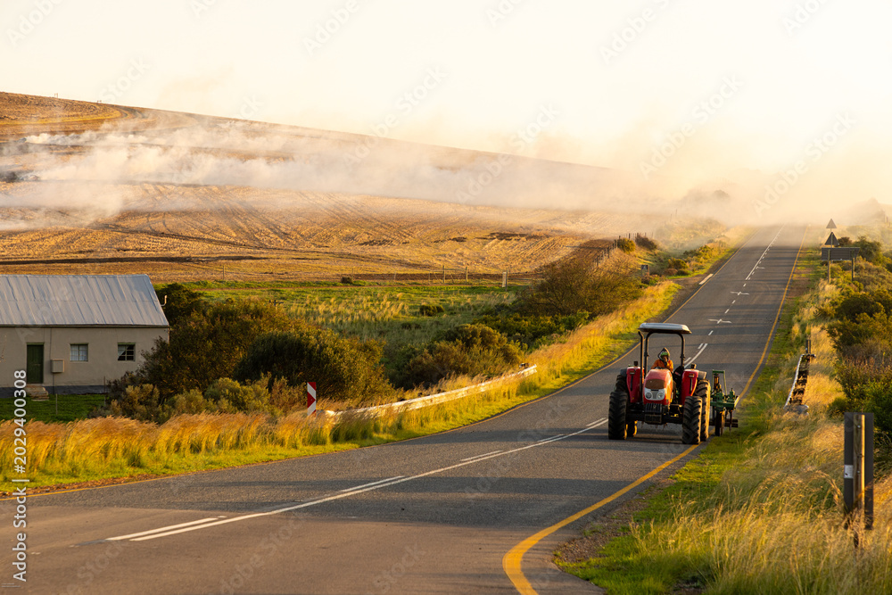 © Marc Romanelli - agricultural burning after harvest, tractor in foreground, western cape, South Africa © Marc Romanelli - agricultural burning after harvest, tractor in foreground, western cape, South Africa