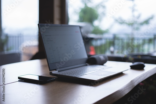 Open laptop on the table. Freelancer's workplace. In the room