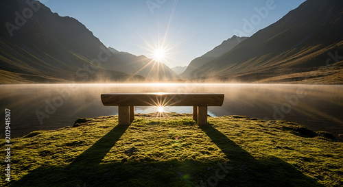 Sunrise over serene mountain lake with wooden bench