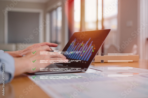 Checklists and Policy and Business Document data system Report workplace safety Concept, Male engineer using tablet and computer laptop checking reports and digital files icon in modern office