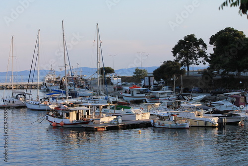 Bild auf Leinwand Yachts and boats moored in Neos Marmaras marina at, sunset, Greece