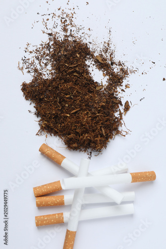 Cigarettes, tobacco and ashtray pile of cigarettes concept of smoking ban.
