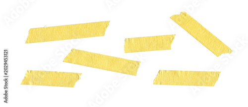 Cuadro en lienzo Yellow adhesive masking tape strips scattered on white background