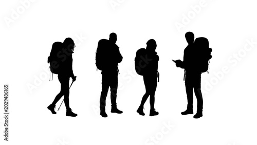 Silhouettes of Four Backpackers Standing and Reading Maps or Guides in a Group
