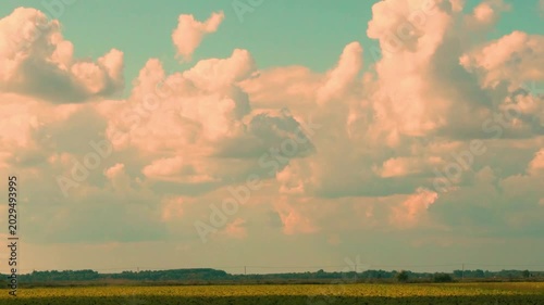 Field and White Yellow Cumulus Clouds Floating across the Blue Sky, Time Lapse, Countryside, Rural, Relaxing Beautiful Background View Fields and Clouds in the Sky at Sunset.