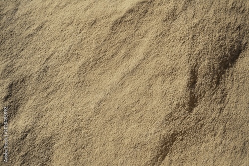 Natural macro texture of soil and sand with organic earthy details. Rustic ground surface background for nature design, branding and creative projects.