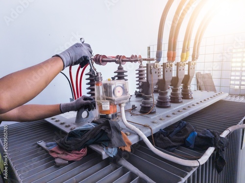 Electrical technicians perform industrial step-down transformer purification