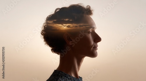 Side profile of a middle aged woman with short curly hair, surreal sunset sky in her silhouette, calm expression, against soft gradient. Digitally altered merges landscape with human form.
