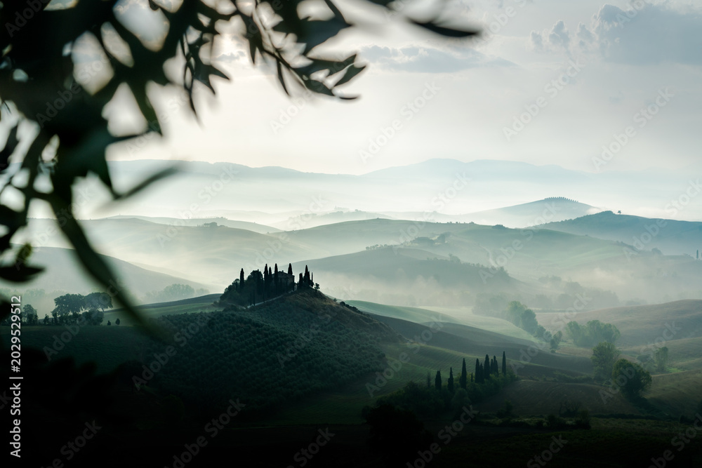 Fototapeta premium Tuscany rolling hills landscape with morning mist at sunrise, Val d'Orcia, Italy 