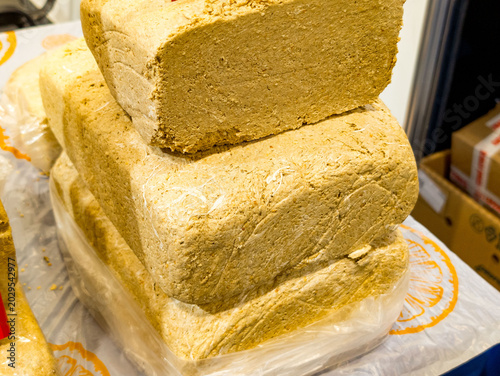 Obraz na plátně Dense blocks of peanut halva resting on a plastic sheet