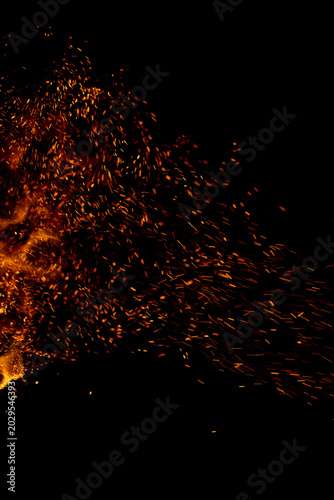 A black background with a lot of orange sparks