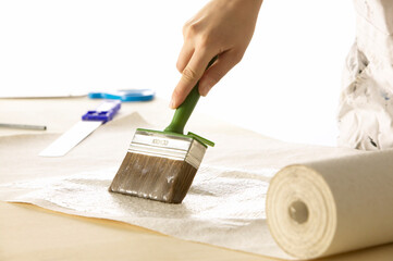 Woman pastes wallpaper