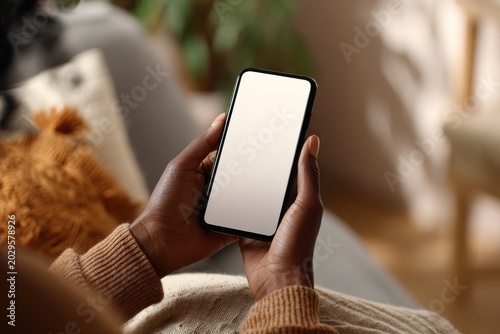 Casual lifestyle shot: woman and a smartphone with a blank screen at home