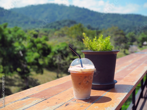 Bilde på lerret A plastic glass of iced coffee latte; upper layer is espresso shot and lower lay