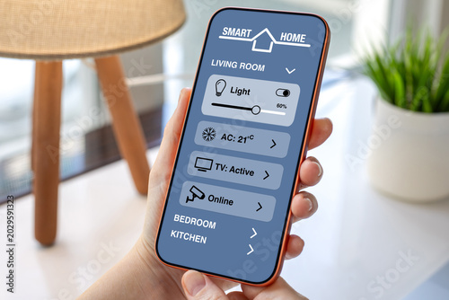 Woman hand holding smartphone with Smart Home control application Interface
