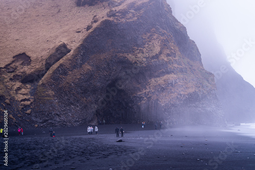 Photos Misty Reynisfjara Black Sand Beach With Basalt Cave and Tourists in Iceland