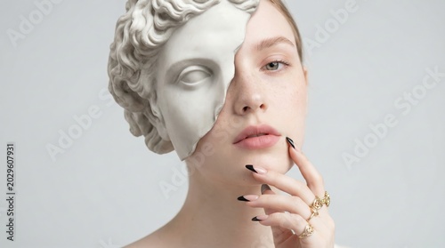 Surreal portrait of a young woman merged with a classical white marble statue representing art and identity.