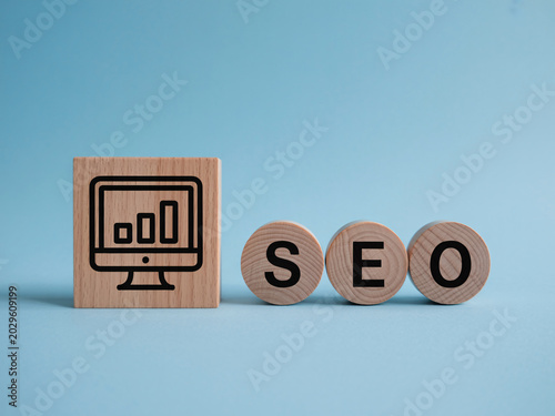 SEO optimization concept with wooden blocks and computer monitor icon