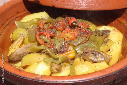 A close-up shot of a moroccan tajine with vegetables, traditional food