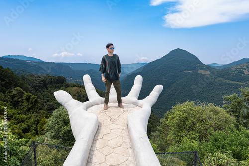 Man standing on giant hand viewpoint in zacatlan