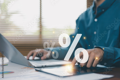 Fényképezés Business finance and percentage analysis concept with professional using tablet and laptop, representing financial data, investment growth, tax calculation, sales performance and digital analytics