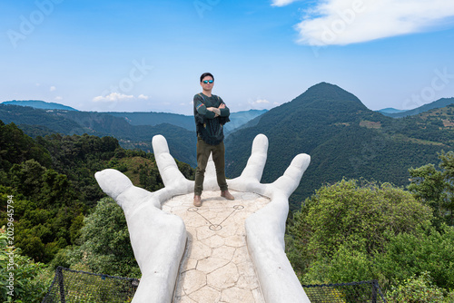 Man standing on giant hand viewpoint in zacatlan
