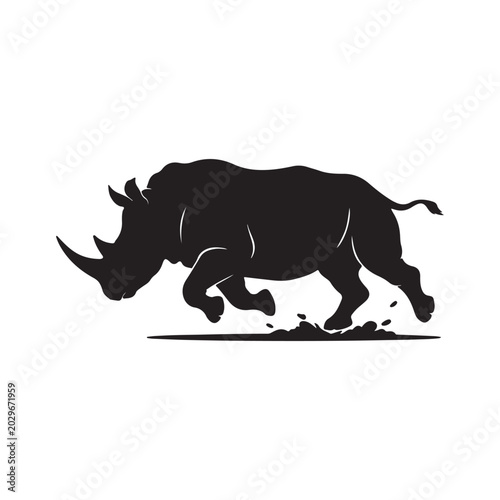 Black rhinoceros silhouette charging with dust and splashes running desi