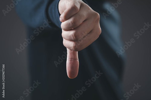 Tablou pe pânză Customer dissatisfaction concept with thumbs down gesture, representing negative
