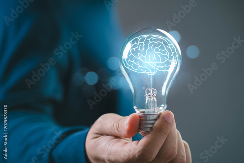 Fotografie Creative intelligence concept with brain inside light bulb, symbolizing innovati