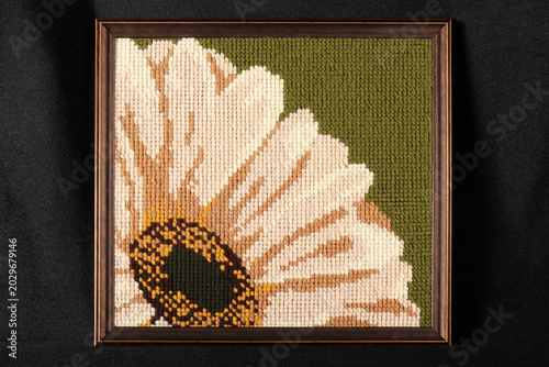 Embroidery on canvas in a glass frame.