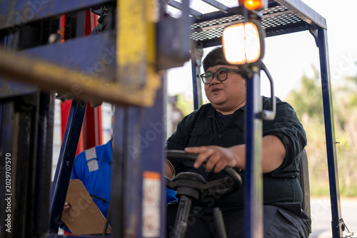 Forklift driver operating machinery in industrial warehouse