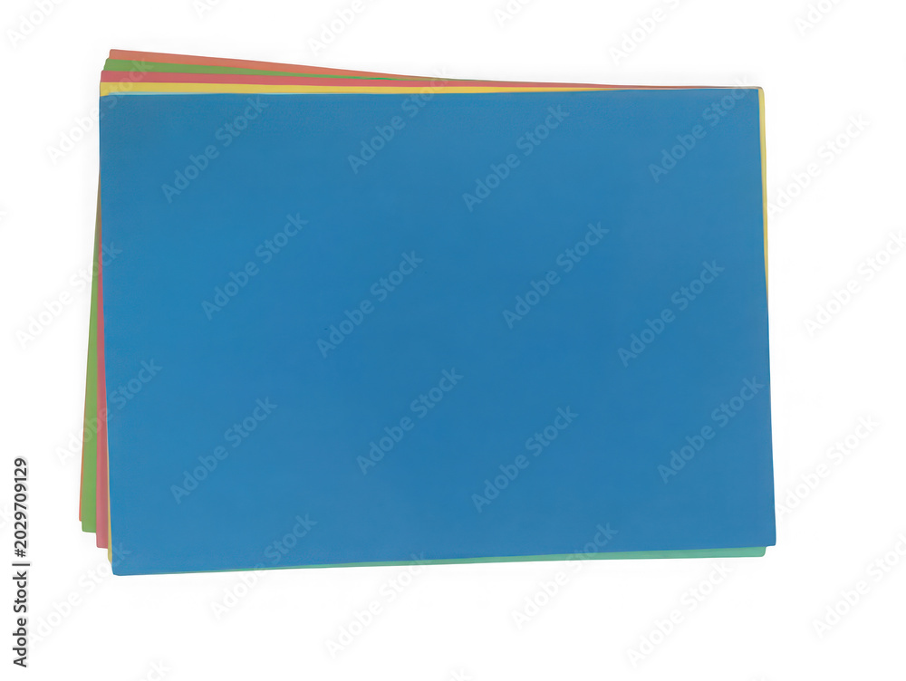 Fototapeta premium Stack of colorful blank paper sheets on a flat surface isolated on white background