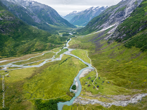 Cuadro en lienzo Aerial drone views of the tundra landscape in Jostedalsbreen National Park, where glacial rivers carve braided channels through a wide alpine valley in western Norway
