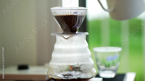 pour over coffee brewing method whole process wood and concrete background trendy cool shadows natural light background