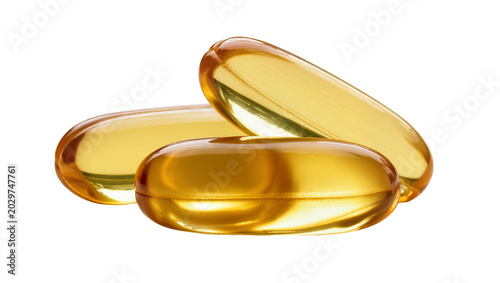 Фотография Three translucent golden oil-filled capsules, isolated on transparent background