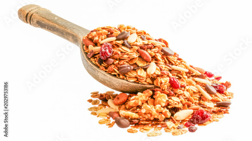 Granola breakfast mix served in a wooden spoon featuring organic oats nuts and dried berries in this studio photograph