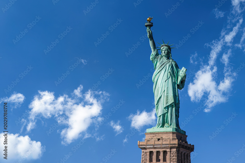 Fototapeta premium High angle view of the Statue of Liberty under blue sky with clouds in New York City, USA.