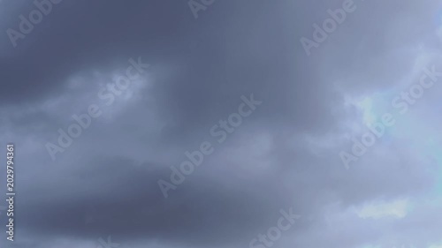 Time-lapse of dark storm clouds passing to reveal a bright blue sky, hope concept