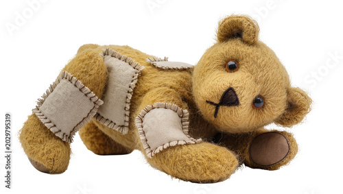 фотографія Patched teddy bear with stitched seams, isolated on transparent background