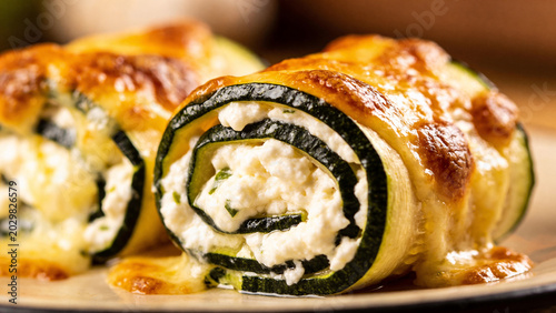 Fresh zucchini rolls with cheese ready to be served at a dinner table