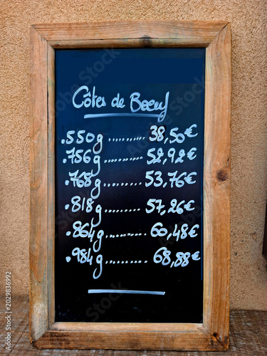 This blackboard outside a restaurant in France shows the available rib of beef pieces with their price. Cotes de Boeuf is the French word for Rib of Beef.