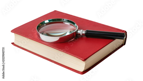 Foto Magnifying glass resting on a closed red hardcover book, isolated on transparent