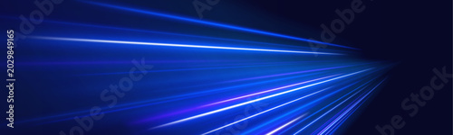 Fotografía Blue neon trails rush along a dark urban road