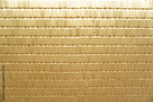 Tableau sur toile Macro shot of a textured cream ceramic surface featuring a rhythmic pattern of v