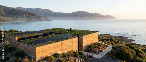 Architecture villa sustainability modern rammed earth house with green roof and solar panels overlooking the ocean at sunset