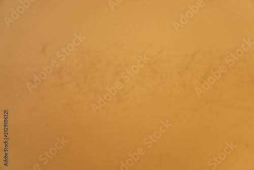 Vászonkép Out of focus abstract shot of a warm ocher wall with faint scratched textures an