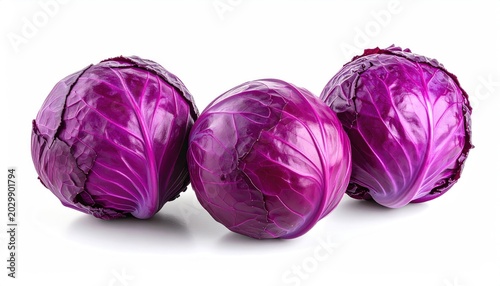 Three vibrant red cabbages with textured leaves on a white background