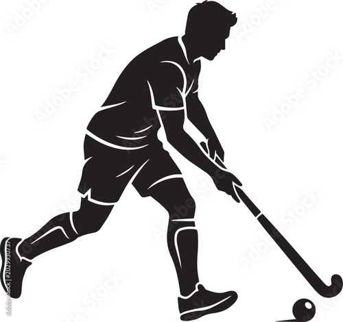 Silhouette of male field hockey player dribbling ball on