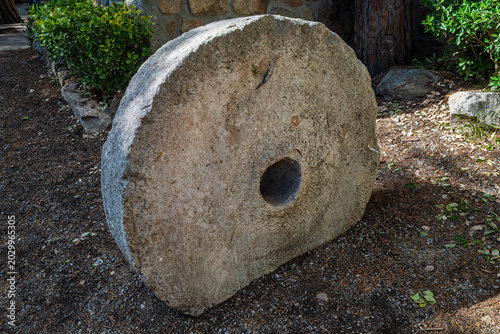 Bild auf Leinwand Historic Grinding Stone Millstone in Outdoor Garden