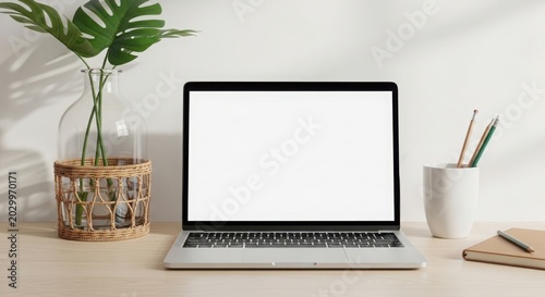 Minimalist home office desk setup with an empty laptop screen for website mockups